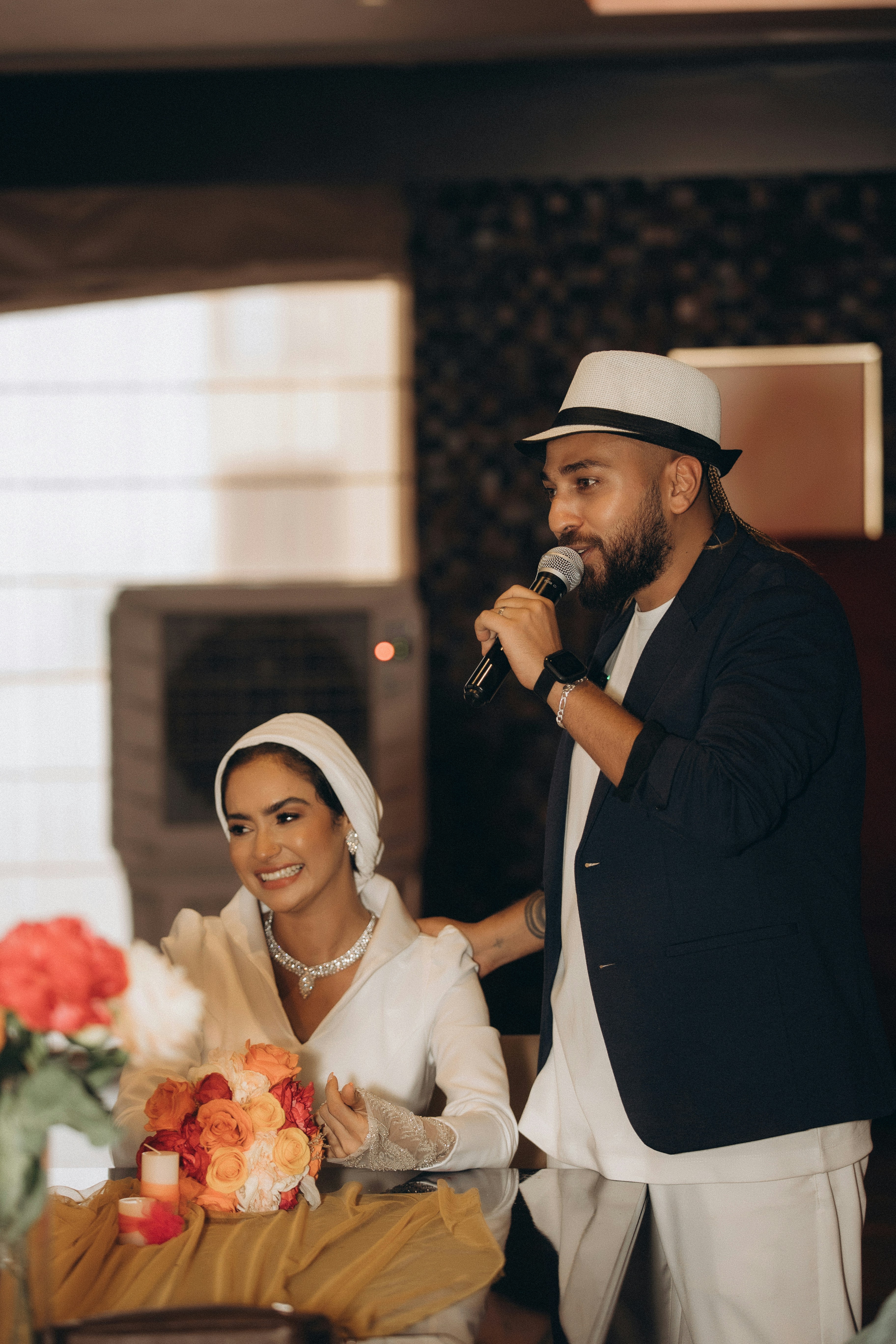 a man standing next to a woman holding a microphone