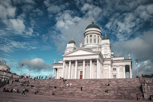 White Helsinki Cathedral with green domes above the broad Senate Square steps