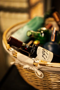 a wicker basket filled with bottles of wine