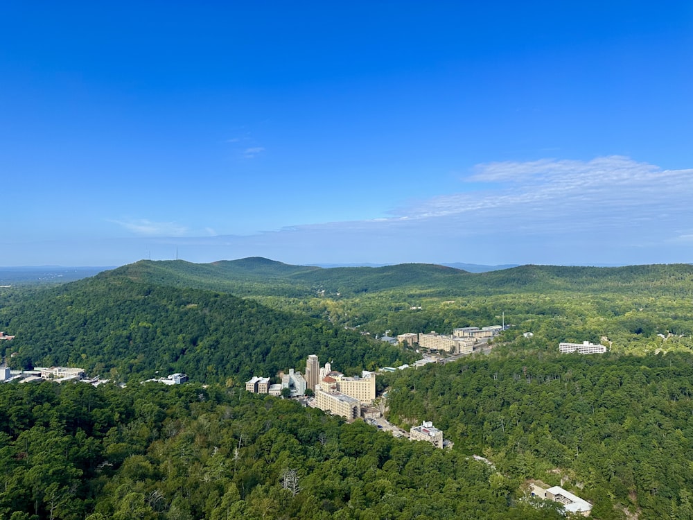 a scenic view of a city surrounded by trees