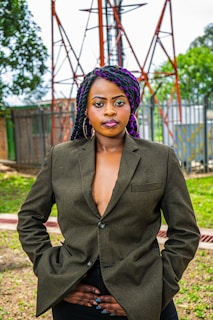 Finished eco-friendly jewelry pieces worn by a confident woman outdoors.