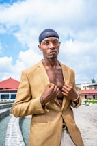 A casual scene with a black African man wearing a stylish kaftan, enjoying a sunny day outdoors.