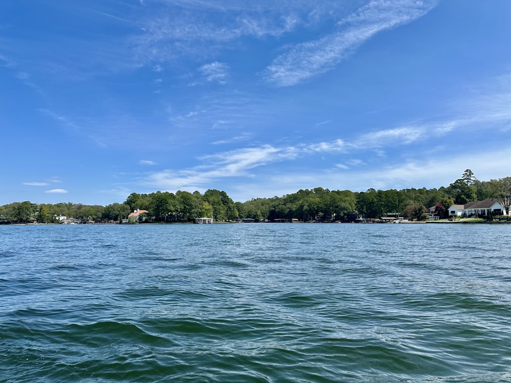 a body of water with houses in the background