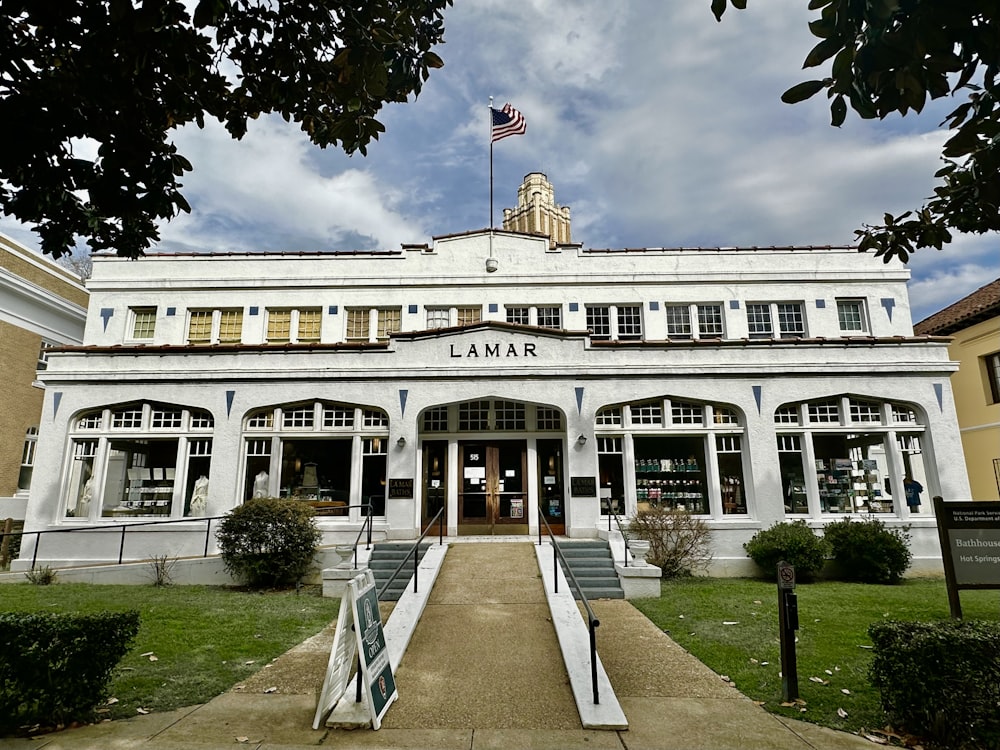 a large white building with a flag on top of it