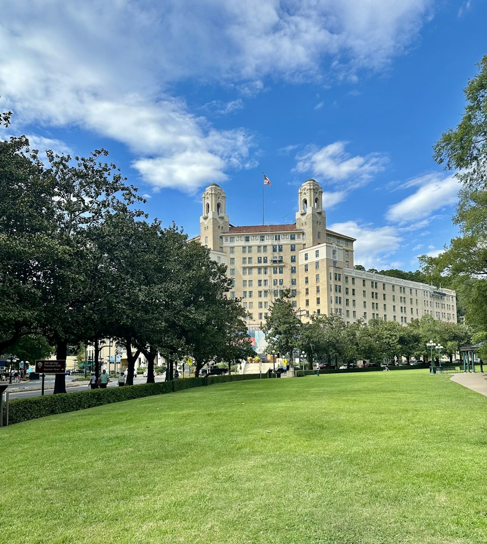 a large building sitting on top of a lush green field