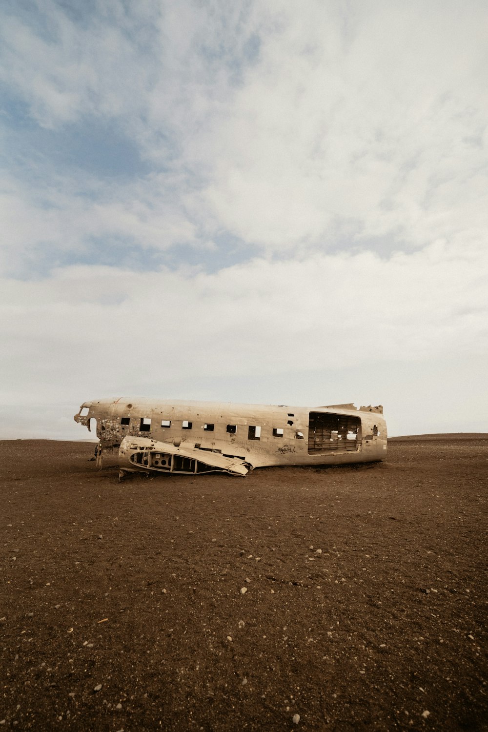 an old plane sitting in the middle of a field