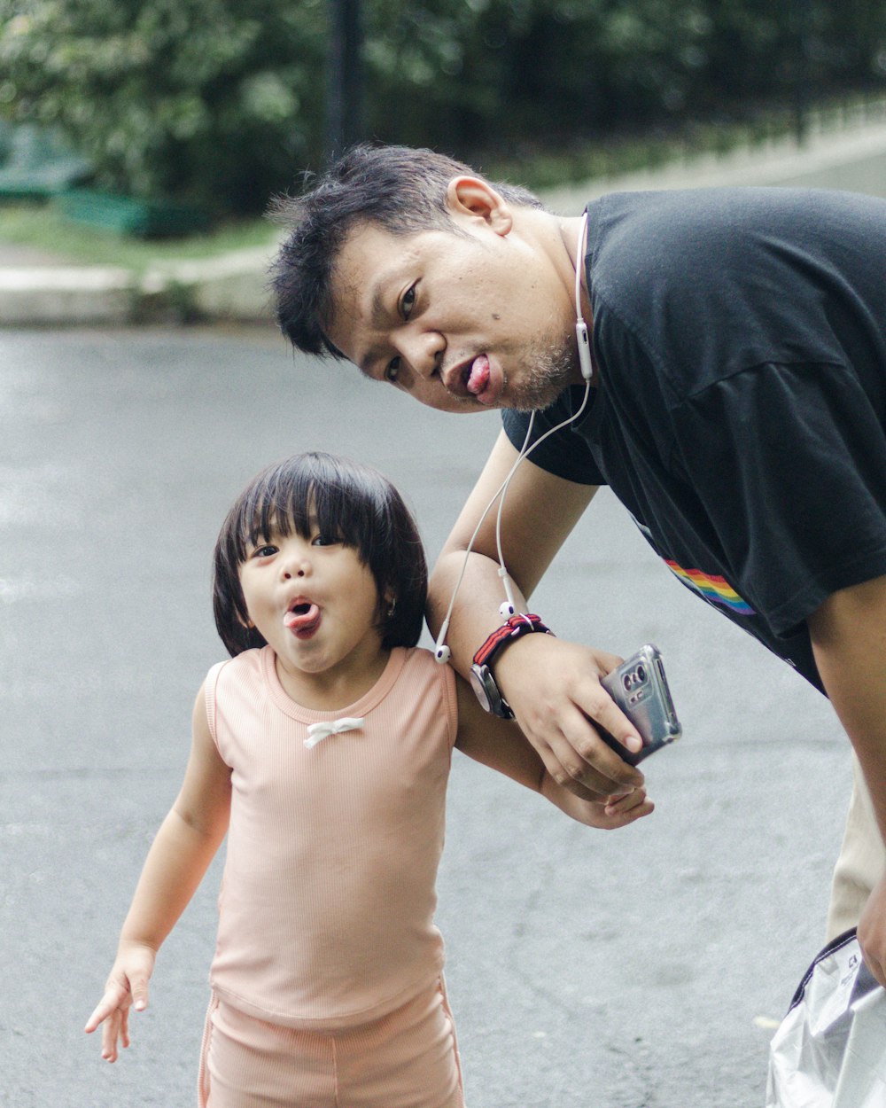 a man and a little girl standing in the street