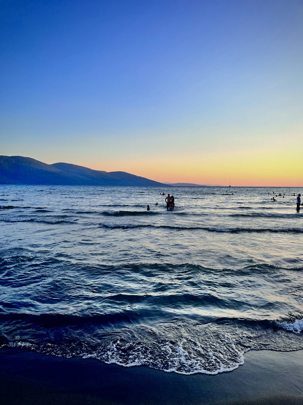 a group of people riding skis on top of a body of water