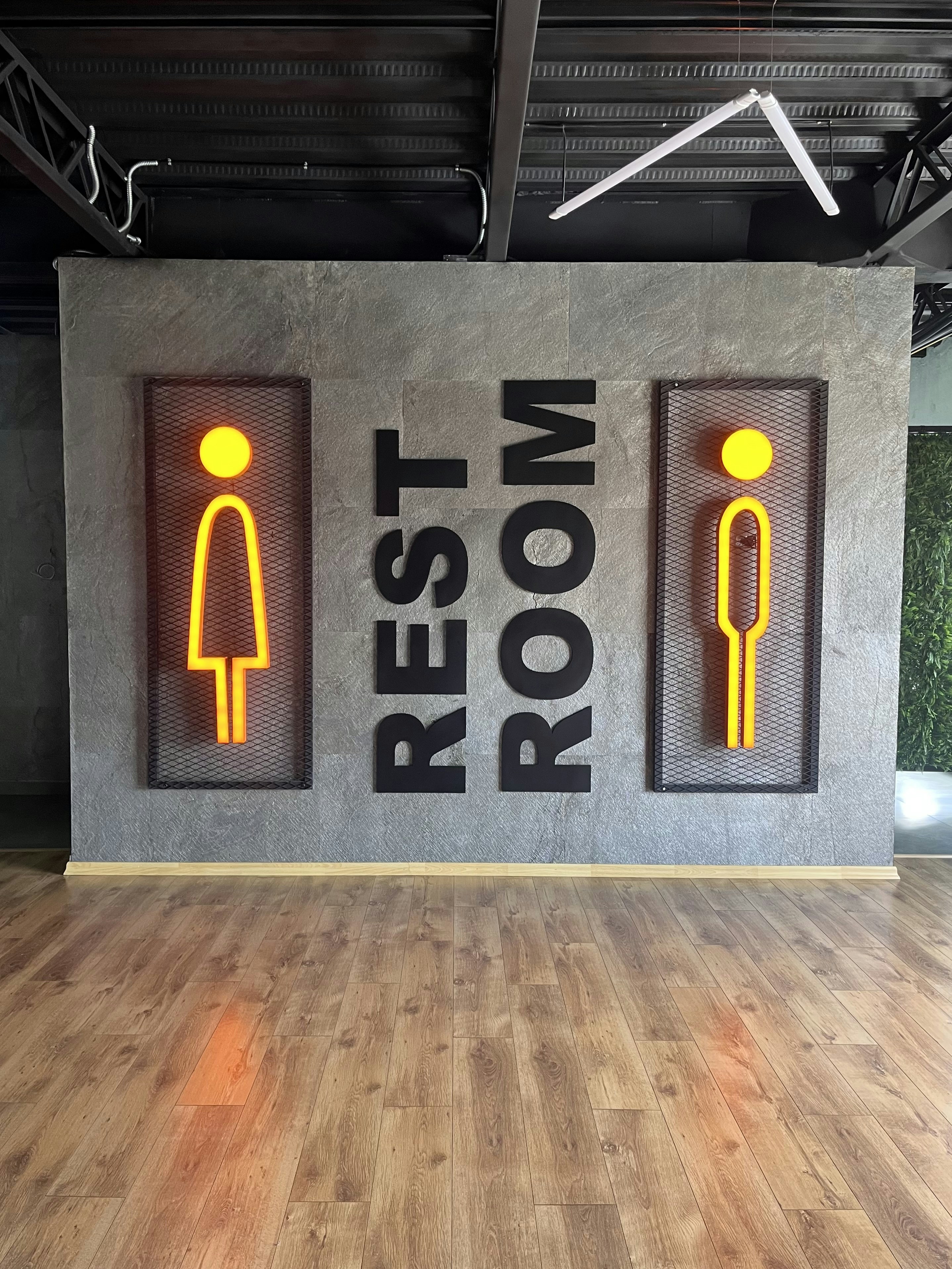 A room with a wooden floor and two neon signs on the wall photo – Free ...