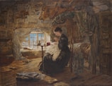 A quiet moment of a woman sewing by a window with soft natural light.