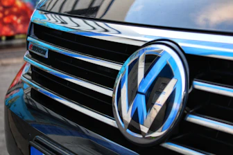 Close-up of a volkswagen car grille with blue accents.