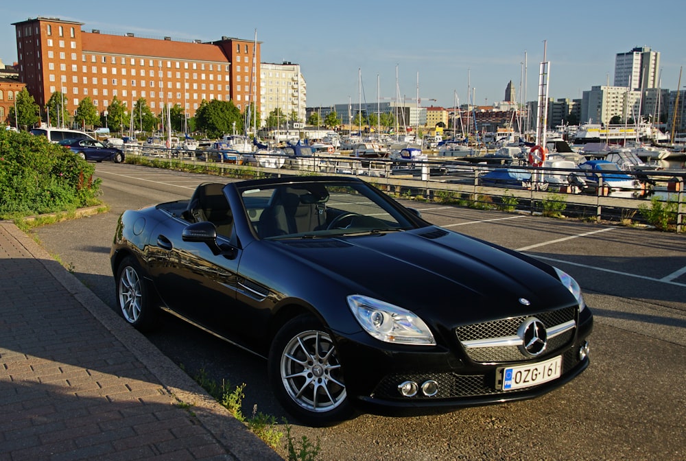 a black convertible car parked on the side of the road