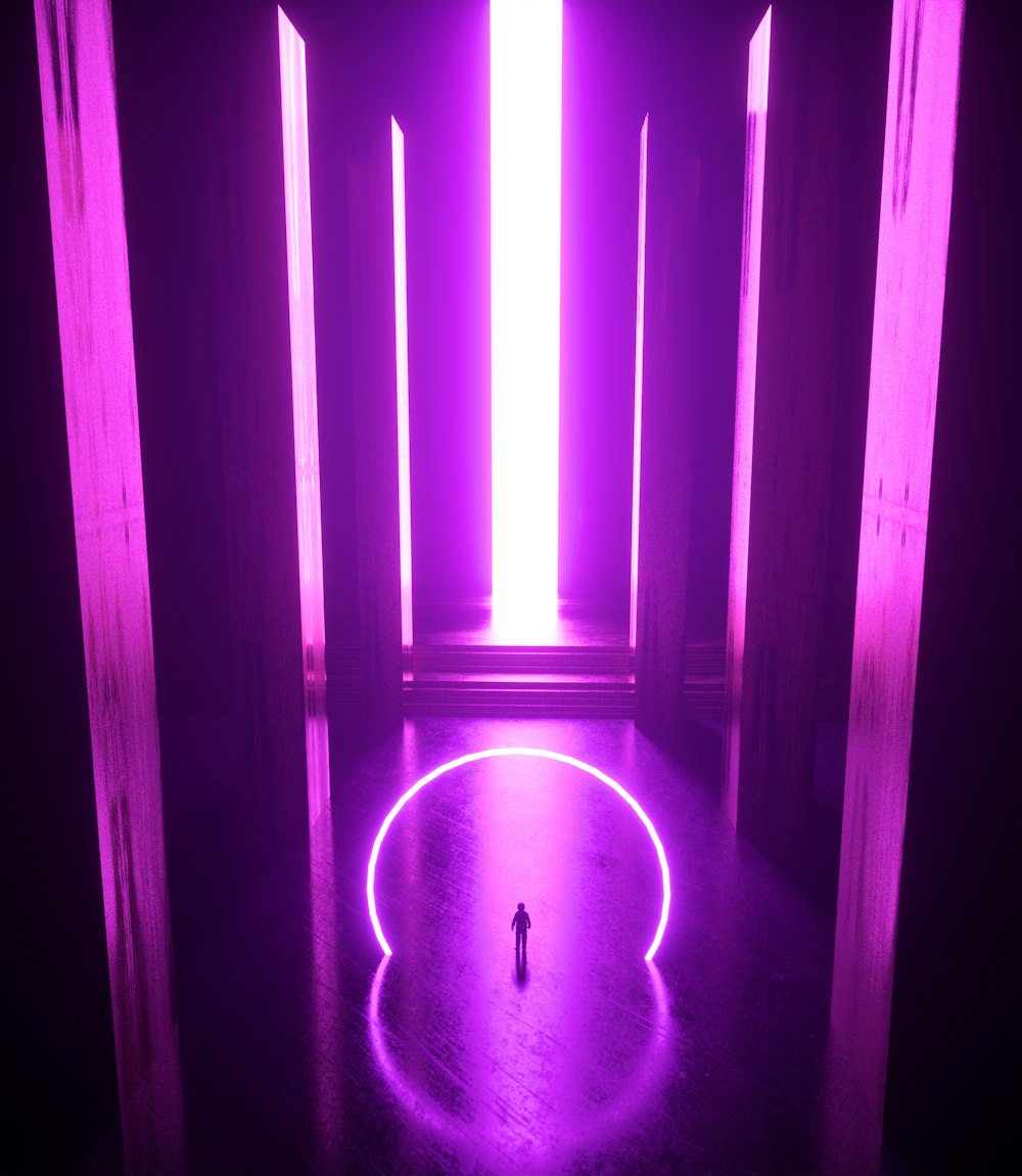 a person standing in a room with purple light
