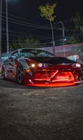 Nighttime photo of a car with illuminated body kit features by tidparts