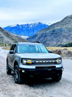 Robust white SUV ready for an off-road adventure in the mountains