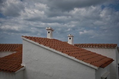 a couple of chimneys on top of a white building