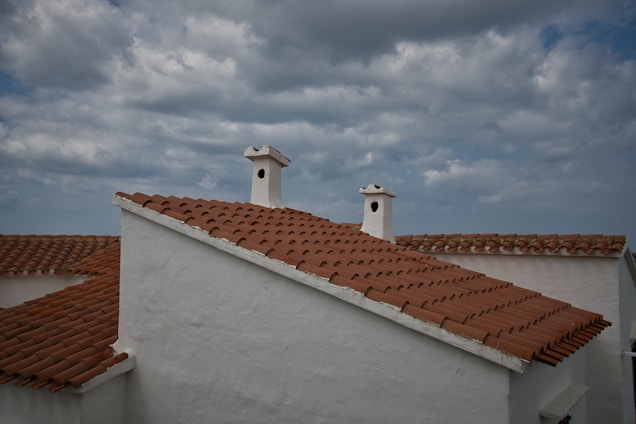 a couple of chimneys on top of a white building