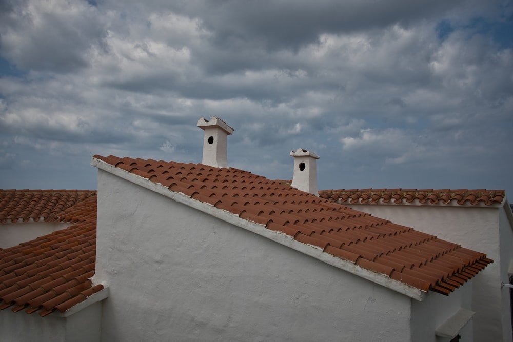 a couple of chimneys on top of a white building