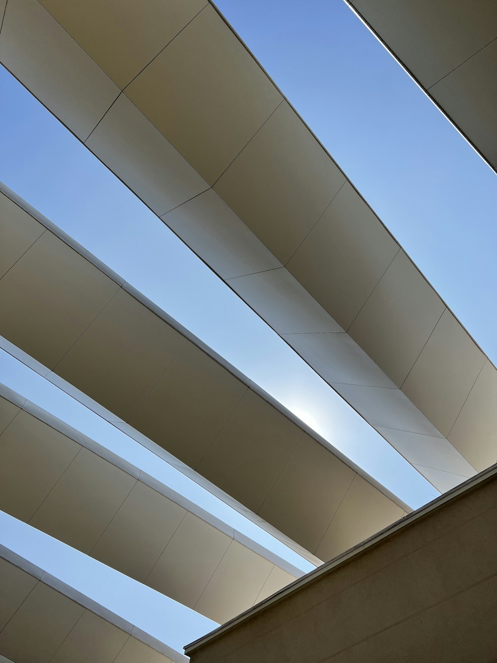 the underside of a building with a blue sky in the background