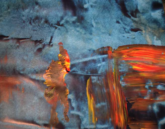 A colorful abstract painting with flowing brush strokes and vibrant blobs on a cream background