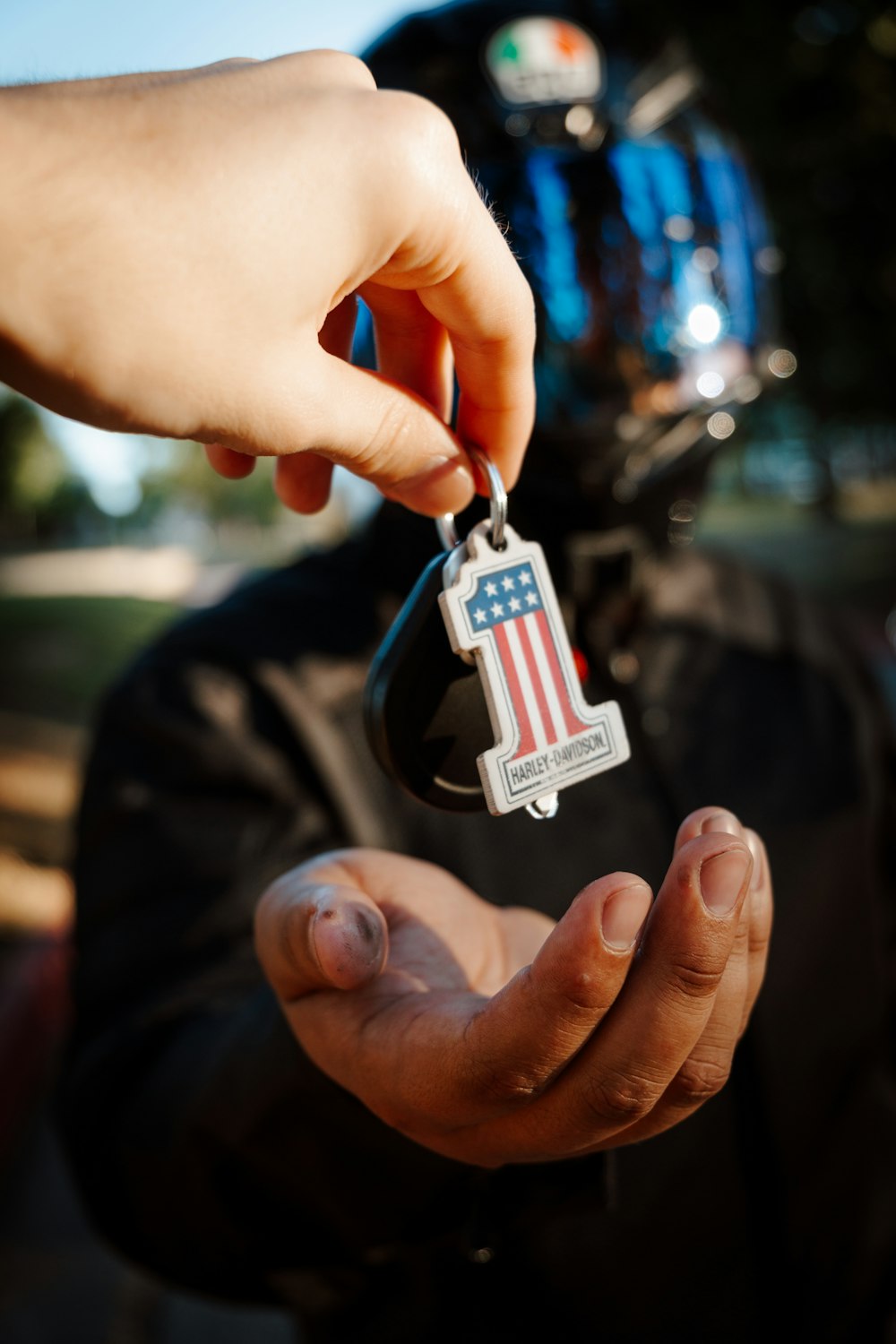 a person holding a car key in their hand