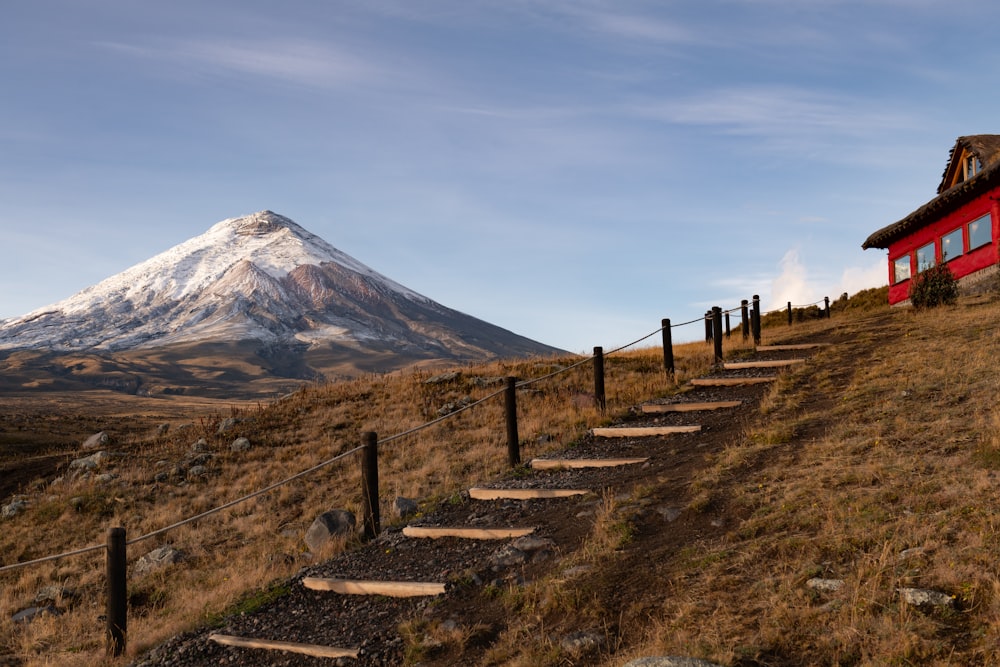 a house on a hill with a mountain in the background