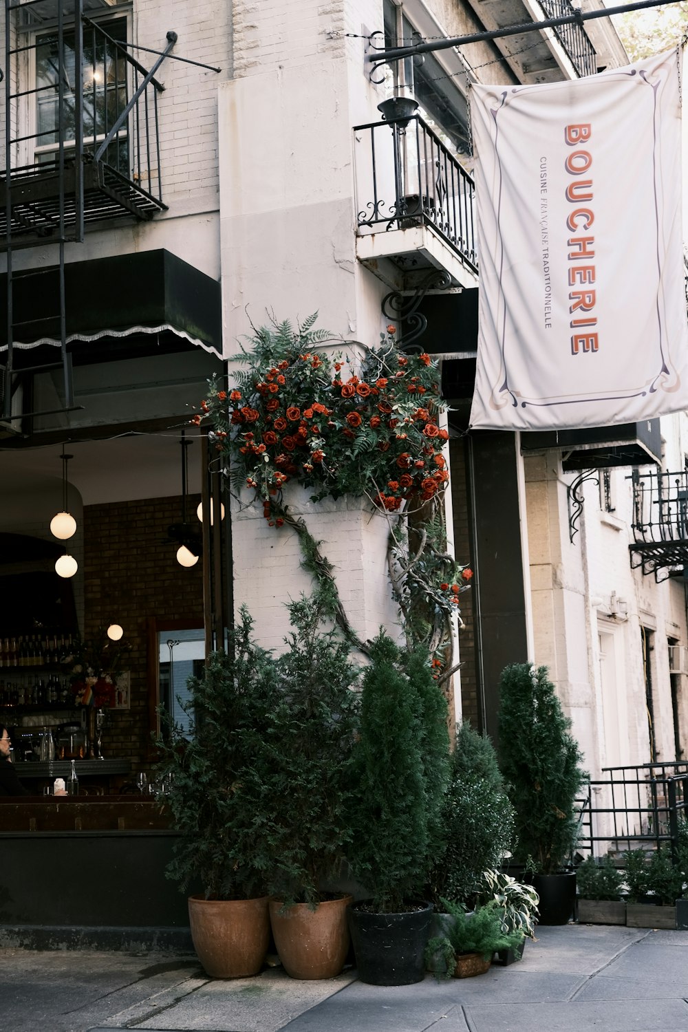 a building with a bunch of potted plants outside of it