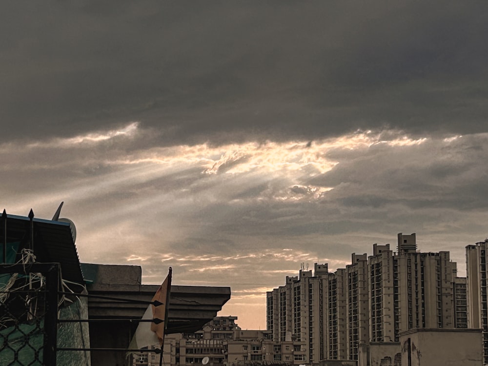 a cloudy sky over a city with tall buildings