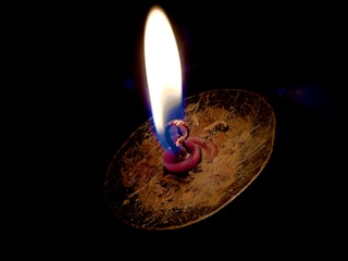A close-up of a candle flame with a glowing effect.