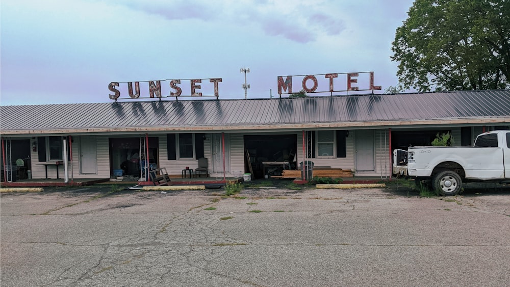 a white truck parked in front of a motel