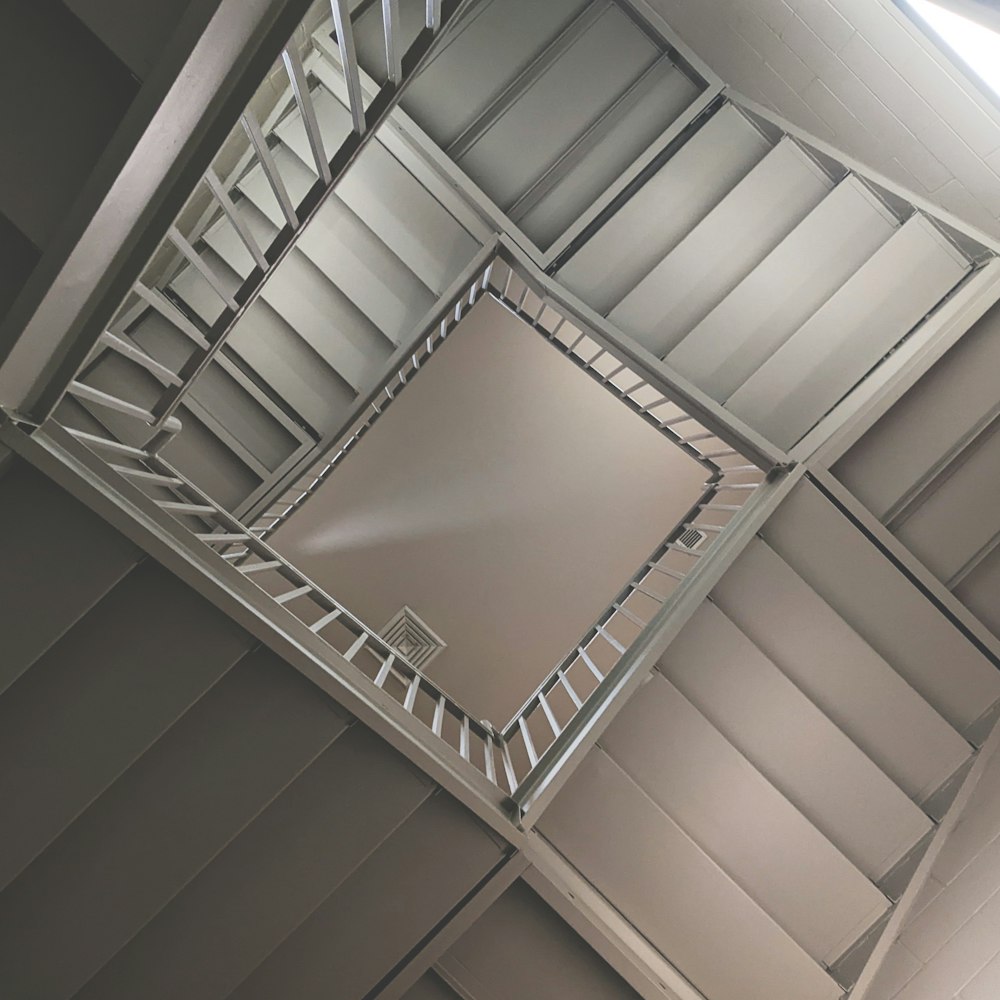 a spiral staircase in a building with a skylight