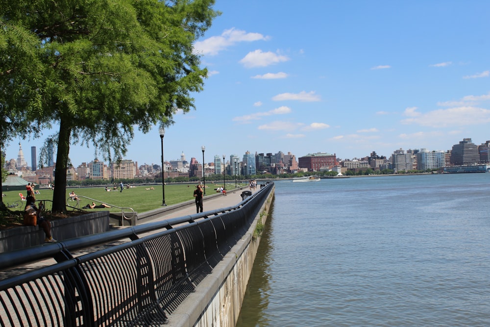 a couple of people that are walking by the water