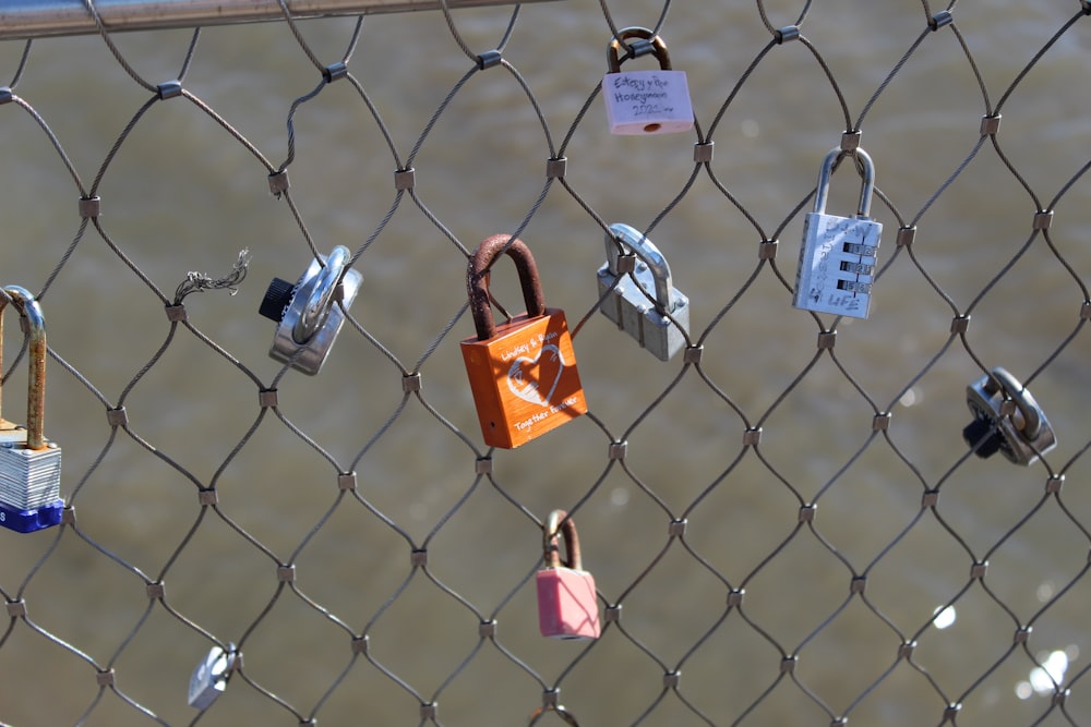 a bunch of padlocks attached to a fence