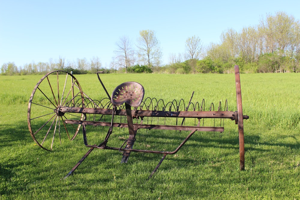 an old farm equipment sitting in a field