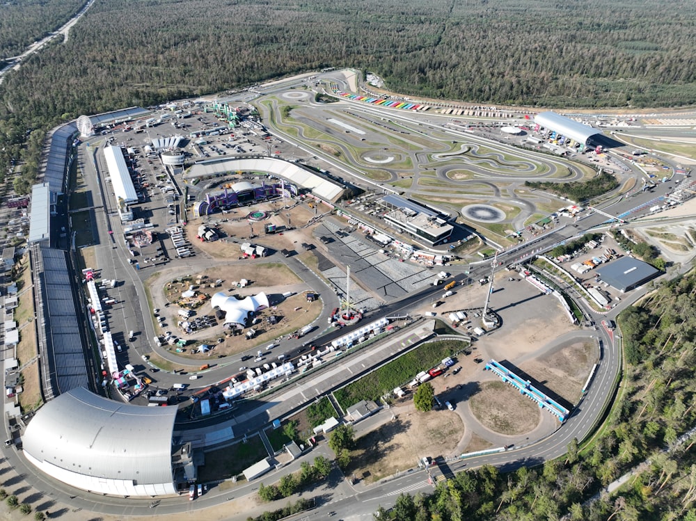 an aerial view of a race track in the middle of a forest