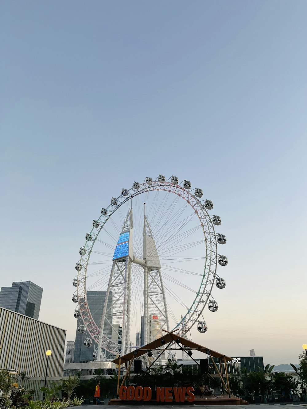 a large ferris wheel sitting in the middle of a city