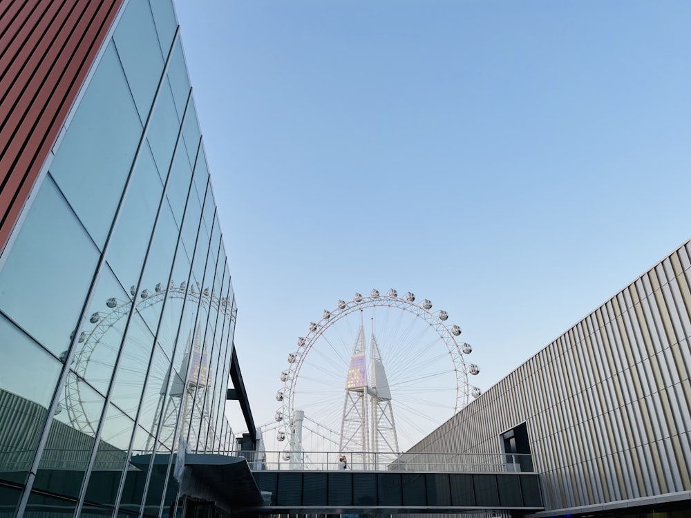 a large ferris wheel sitting next to a tall building