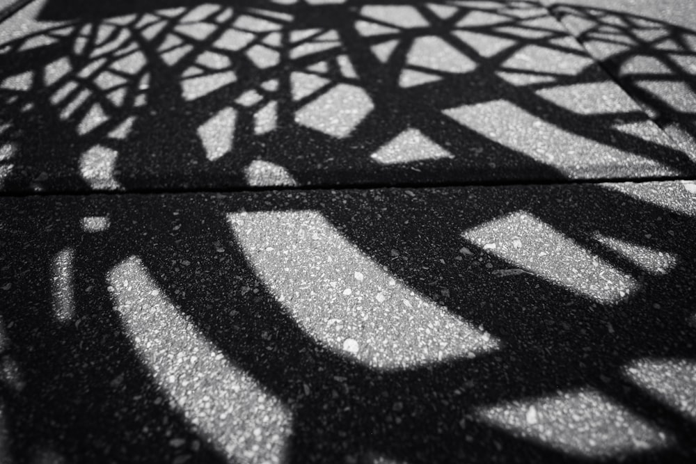 the shadow of a bicycle wheel on the ground