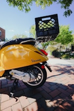 Vintage Piaggio Ape triporteur decorated with Sicilian cart motifs parked in a sunny Aix-en-Provence street.