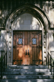 Detailed view of wrought iron door handles and decorative elements, emphasizing artisanal work.