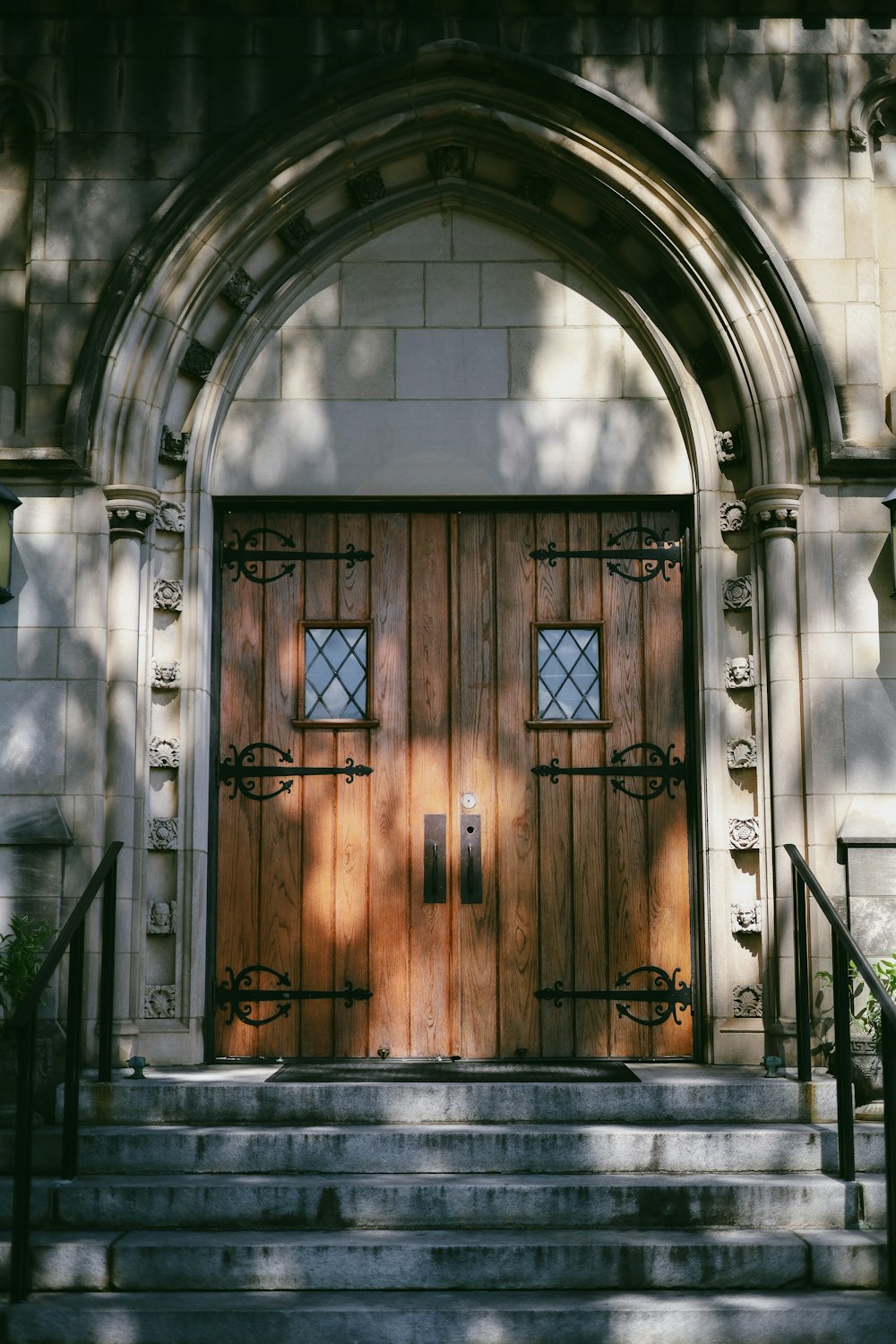 a large wooden door sitting on the side of a building