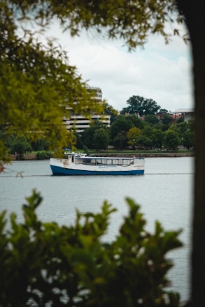 A scenic view of a boat gliding through the calm waters of the Hudson River.