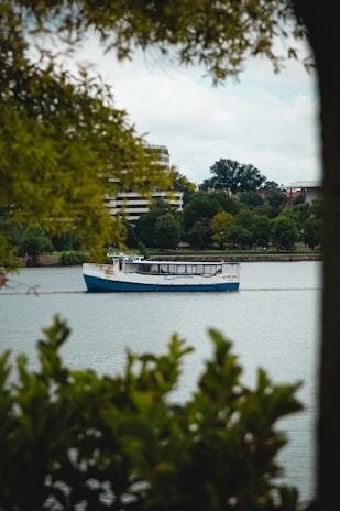 A scenic boat cruising through calm blue waters with passengers enjoying the view.
