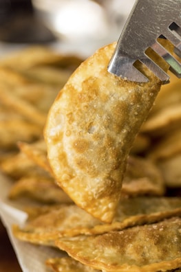 Close-up of a golden, crispy cheburek filled with juicy beef.