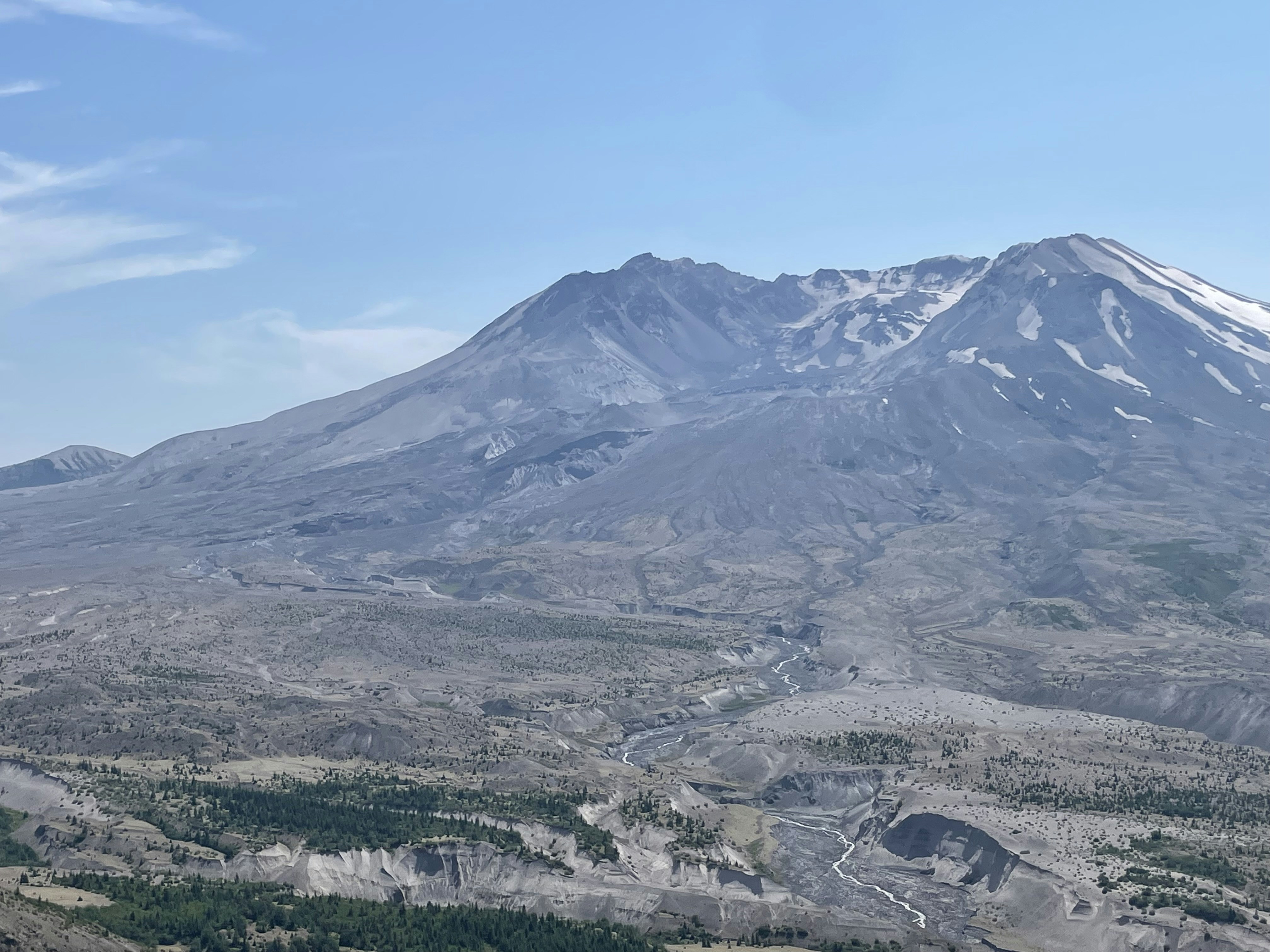 a view of a mountain with a river running through it