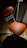 A softly glowing orange chair bathed in warm light, set against a dark, mysterious background.