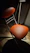 A softly glowing orange chair bathed in warm light, set against a dark, mysterious background.