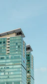 A commercial office building with solar glass facades and advanced energy monitoring displays.