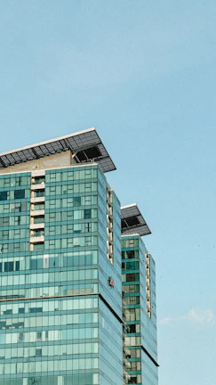 A commercial office building with solar glass facades and advanced energy monitoring displays.