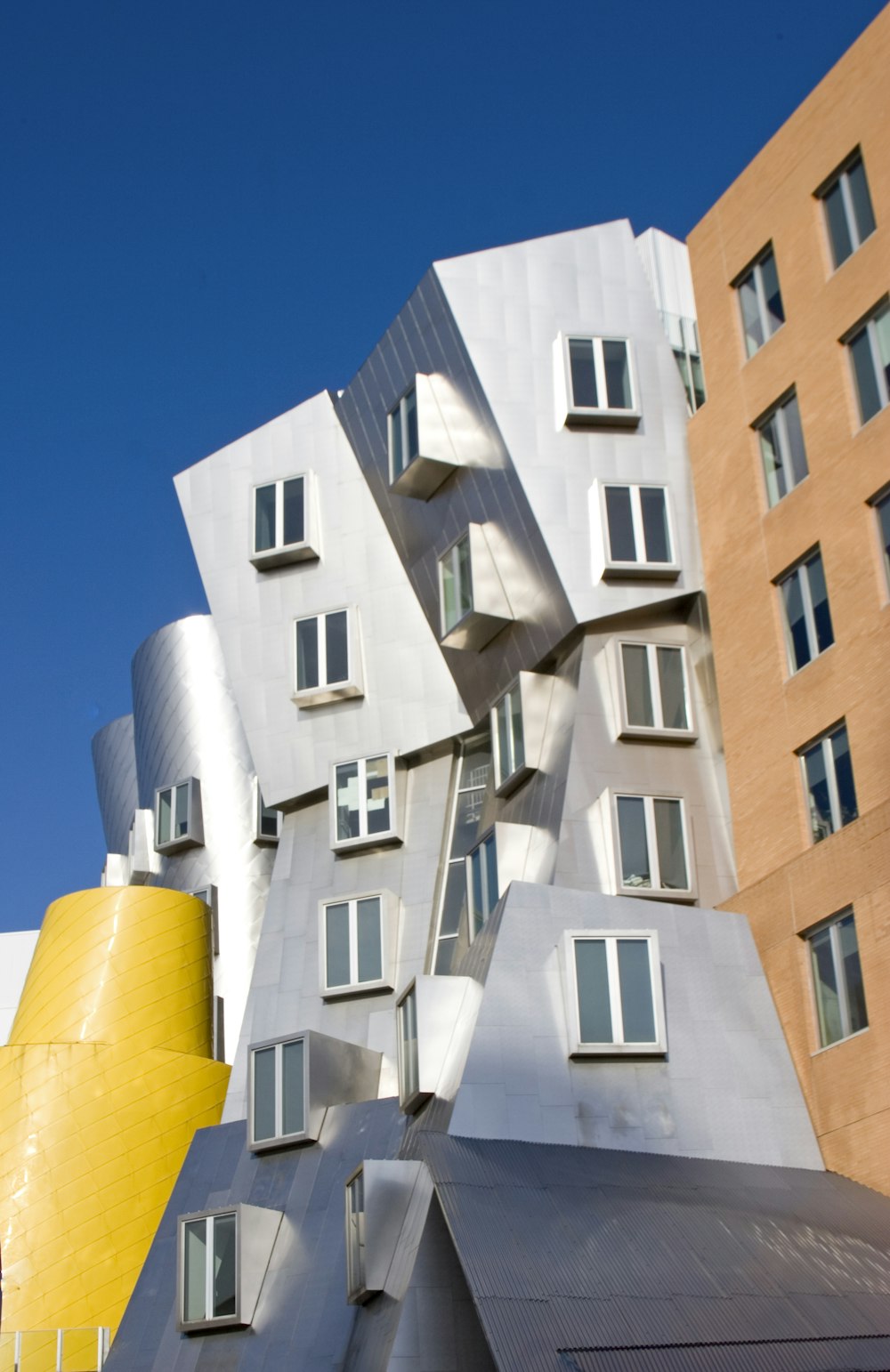 a tall building with many windows next to a tall building